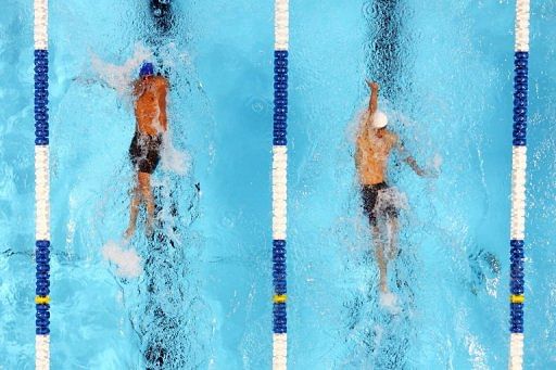 Lochte (left) is ahead of Phelps (right) during the backstroke section of the Men&#039;s 400m IM on June 25