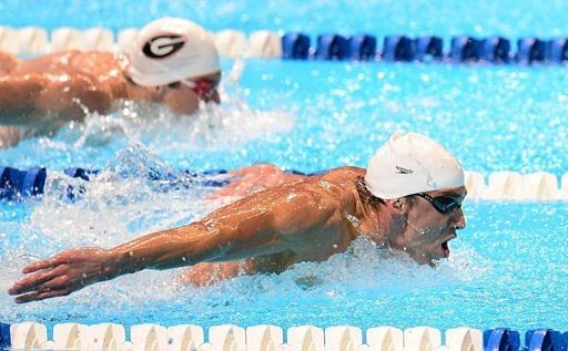 Michael Phelps (R) swims to victory ahead of Mark Dylla in Heat 14 of the men&#039;s 200m butterfly