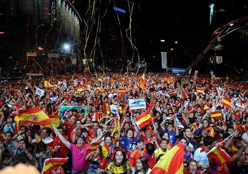 Supporters of the Spanish football team wave national flags in Madrid