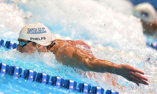 Michael Phelps swims to a first place finish in the men&#039;s 100m butterfly final