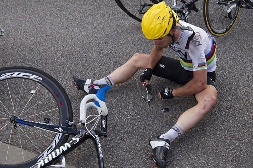 Mark Cavendish reacts on the ground after a crash