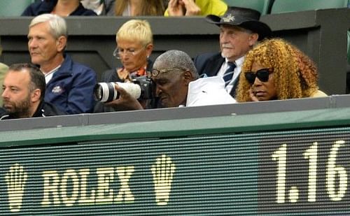 Parents of Venus and Serena Williams, Richard Williams (C) and Oracene Price, watch the doubles final