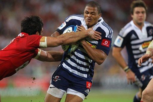 Western Stormers&#039; Gio Aplon (R) is being tackled by Queensland Reds&#039; Rod Davies