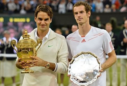 Switzerland's Roger Federer (L) poses with the trophy with loser Britain's Andy Murray (R)