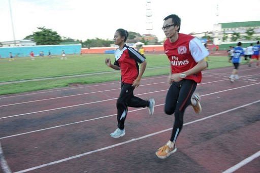 Kilakone Siphonexay (R) and Lealy Phoukhavont (L) during a training session at the stadium in Vientiane