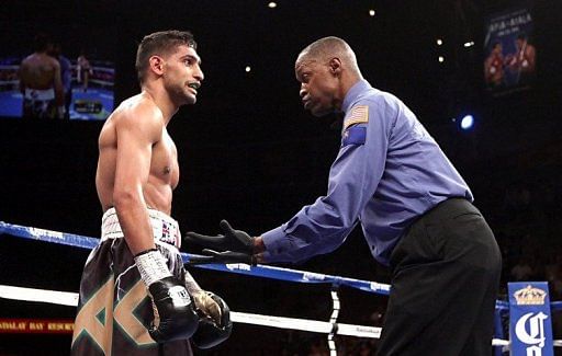 Referee Kenny Bayless gives Amir Khan a count after he was knocked down by Danny Garcia