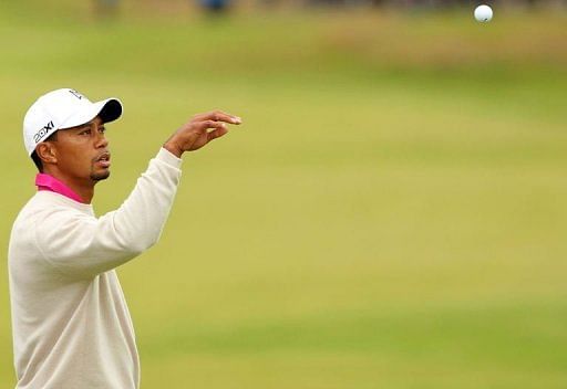 Tiger Woods of the US catches his ball on the 7th green