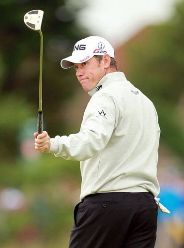 Lee Westwood of England reacts to making a birdie putt on the 2nd green