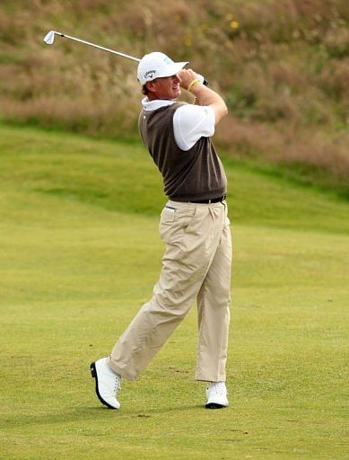 Ernie Els of South Africa watches his second shot from the 4th fairway