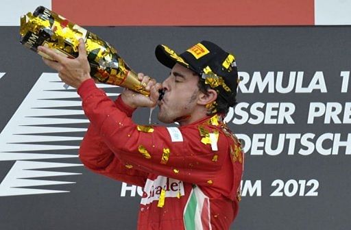 Ferrari&#039;s Spanish driver Fernando Alonso celebrates on the podium