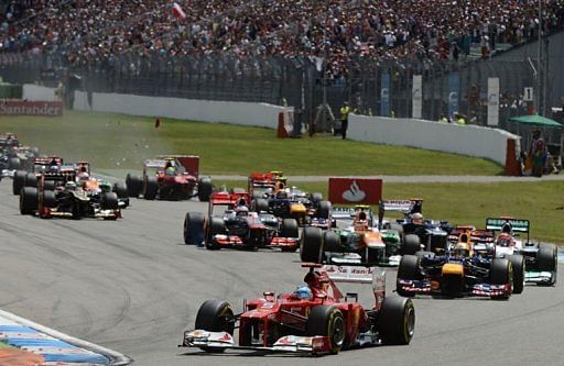 Ferrari&#039;s Spanish driver Fernando Alonso leads after the start