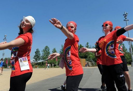 Volunteers enact Olympic sporting events at the Olympic Stadium in London