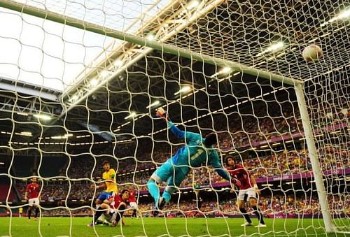 Brazil's striker Neymar (L) scores the third goal