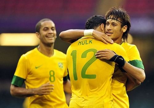 Brazil's striker Neymar (R) celebrates scoring the third goal with striker Hulk