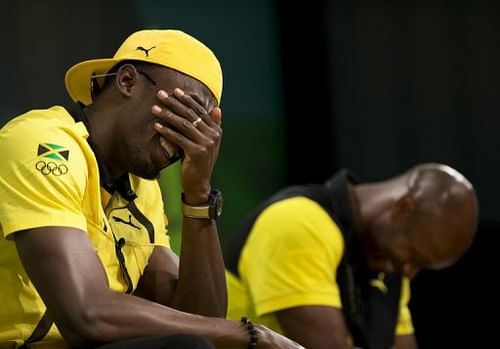 Bolt shares a laugh with teammate Asafa Powell in an Olympic press conference