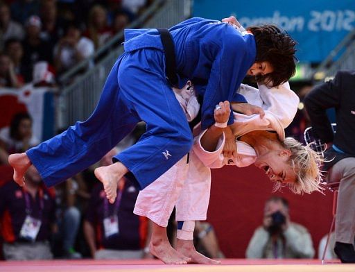 Hungary&#039;s Eva Csernoviczki (white) competes with Japan&#039;s Tomoko Fukumi
