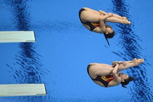 China&#039;s Wu Minxia and He Zi dive during the women&#039;s synchronised 3m springboard diving event