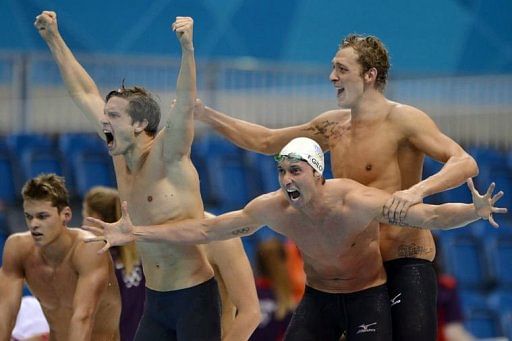 France&#039;s Clement Lefert, Amaury Leveaux and Fabien Gilot celebrate after winning the men&#039;s 4x100m freestyle relay final