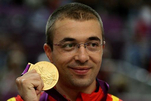 Moldoveanu (shown with his gold medal on Monday) held his nerve to beat world champion Niccolo Campriani