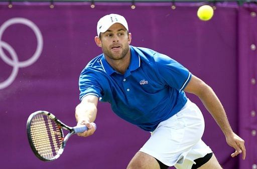 Andy Roddick returns the ball to Martin Klizan during the first round Monday