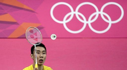 Malaysia&#039;s Lee Chong Wei returns a shot to Ville Lang of Finland