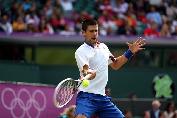 Djokovic survives a fighting Hewitt to reach the quarter-finals