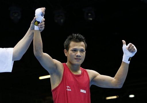 Devendro Singh Laishram of India is declared winner after stopping Bayron Molina Figueroa of Honduras