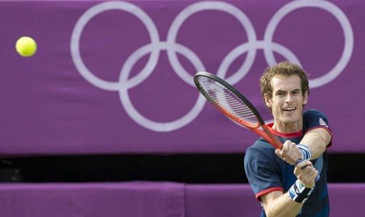 Britain&#039;s Andy Murray returns a shot to Cyprus&#039; Marcos Baghdatis