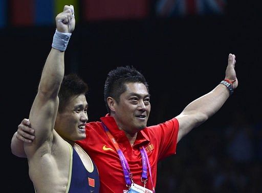 China&#039;s Lu Xiaojun (L) celebrates with his coach