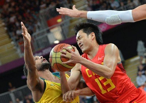 Chinese guard Chen Jianghua vies with Patrick Mills (left)