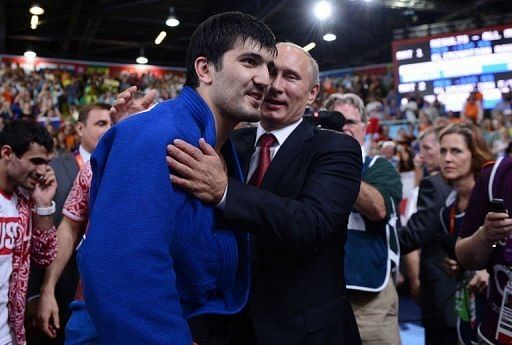 Russia&#039;s Tagir Khaibulaev (L) is congratulated by Russian President Vladimir Putin