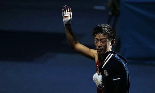 Satoshi Shimizu of Japan waves to the cheering crowd as he departs the ring on August 1