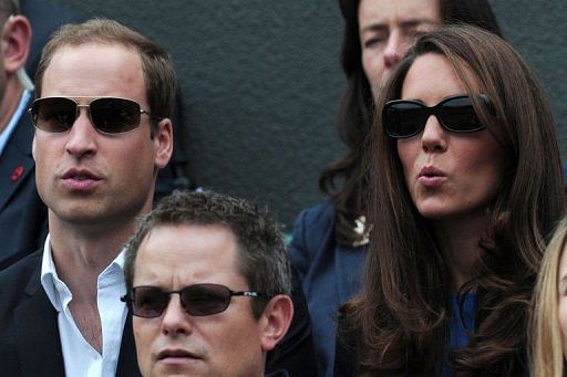 Britain&#039;s Catherine (R) and William, Duchess and Duke of Cambridge, react as they watch Andy Murray