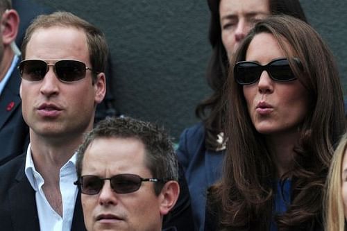 Britain's Catherine (R) and William, Duchess and Duke of Cambridge, react as they watch Andy Murray