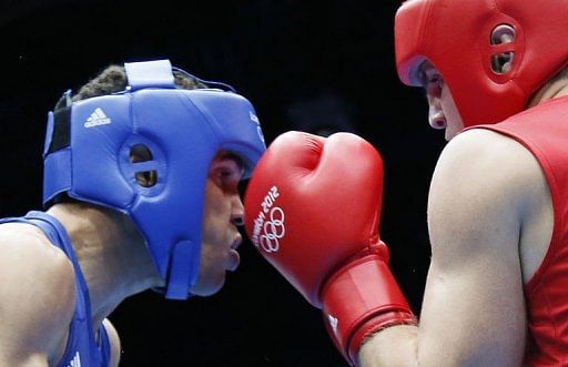 Ievgen Khytrov (R) of the Ukraine defends against Anthony Ogogo (L) of Great Britain