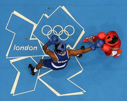 Vasyl Lomachenko (R) of the Ukraine defends against Wellington Arias Romero (L) of the Dominican Republic