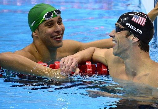 US swimmer Michael Phelps is congratulated by second-placed South Africa&#039;s Chad Le Clos