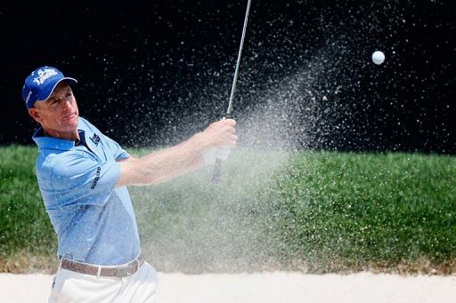 Jim Furyk fired a four-under 66 to maintain his two-shot lead at the halfway stage of the WGC-Bridgestone Invitational