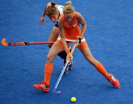 Carlien Dirske Van Den Heuvel (front) of the Netherlands attempts to go past Kim Young Ran of South Korea