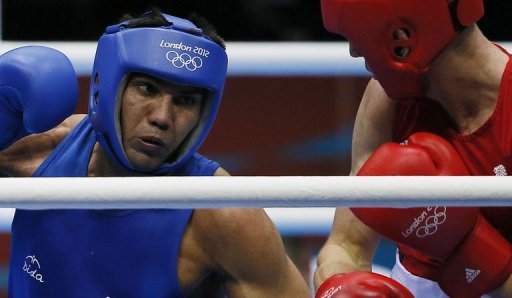 Manoj Kumar (L) of India defends against Thomas Stalker (R) of Great Britain