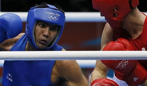 Manoj Kumar (L) of India defends against Thomas Stalker (R) of Great Britain