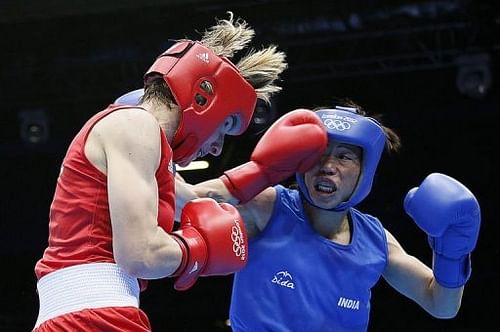 Karolina Michalczuk (L) of Poland defends against M.C. Mary Kom (R) of India