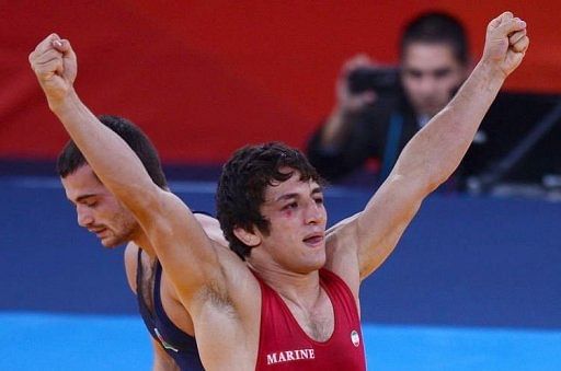 Iran’s Hamid Soryan Reihanpour celebrates after defeating Azerbaijan’s Rovs...