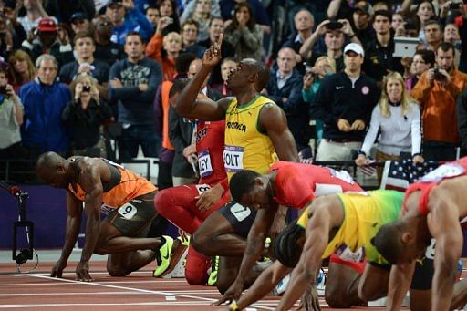 Jamaica&#039;s Usain Bolt (C) looks up prior to taking the start of the men&#039;s 100m