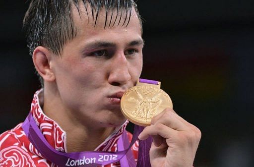 Russian gold medalist Roman Vlasov kisses his medal