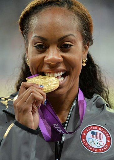 USA&#039;s gold medalist Sanya Richards-Ross celebrates on the podium