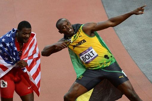 Gold medalist Jamaica&#039;s Usain Bolt (R) celebrates with bronze medalist USA&#039;s Justin Gatlin