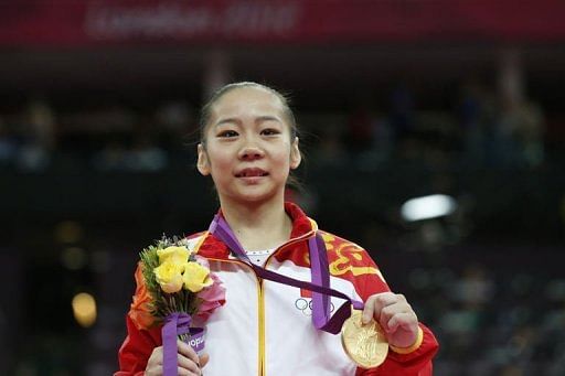 Gold medalist China&#039;s gymnast Deng Linlin poses on the podium