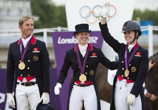 L-R: Britain&#039;s Carl Hester, Laura Bechtolsheimer and Charlotte Dujardin celebrate after taking gold i