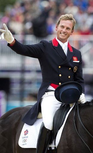 Britain&#039;s Carl Hester waves after competing in the grand prix dressage event